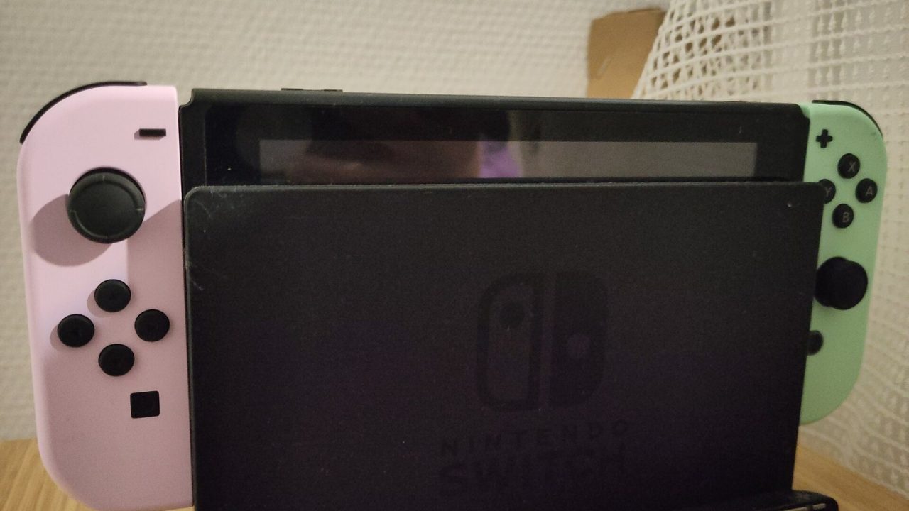 Nintendo Switch in its dock with Animal Crossing edition Joy-Con controllers