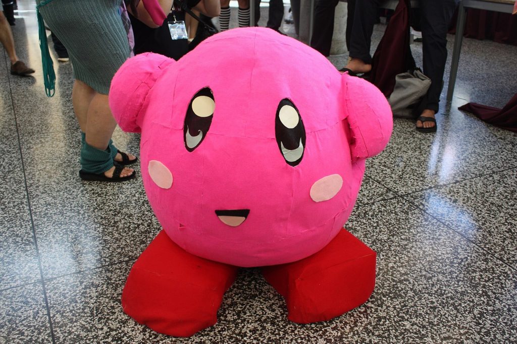 Large pink Kirby plush sitting on the floor at the Otakuthon 2014 convention
