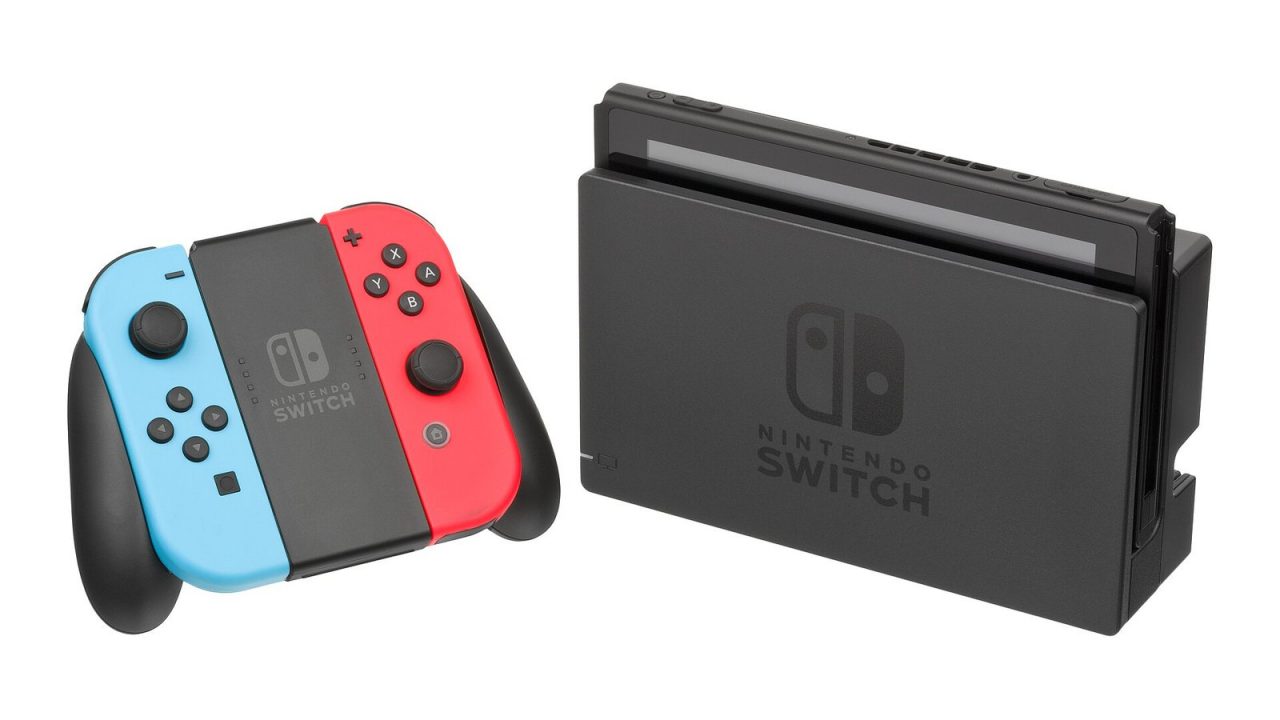 Original Nintendo Switch in its dock with red and blue Joy-Con in the grip