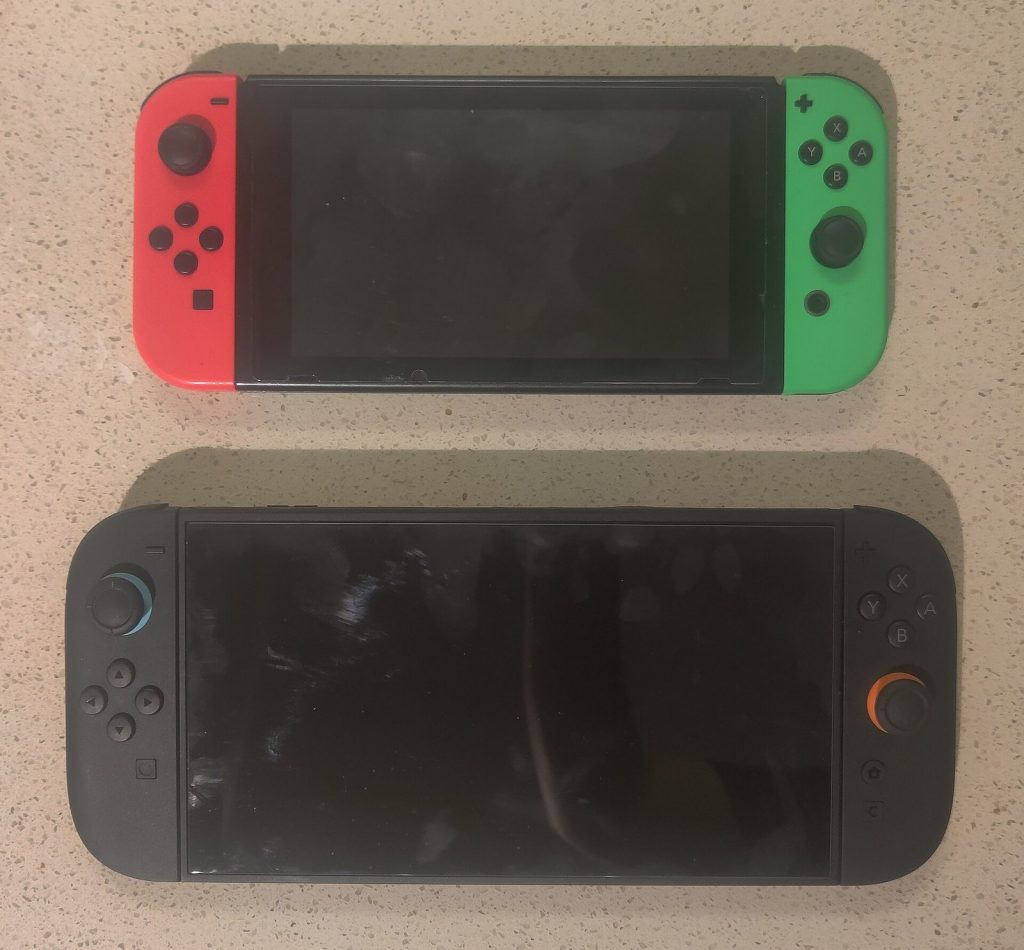 Original Nintendo Switch placed above a larger Nintendo Switch 2 to compare their size