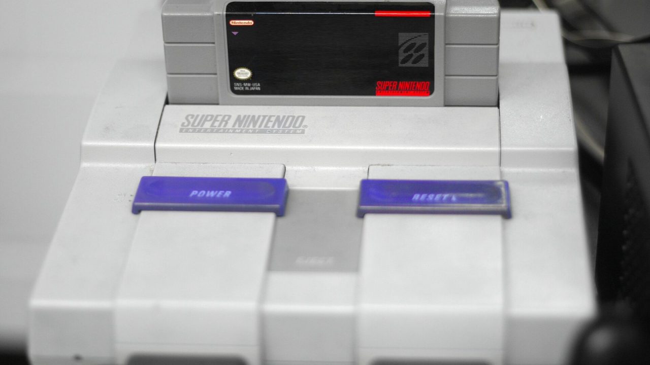 Super Mario World cartridge inserted in a Super Nintendo console